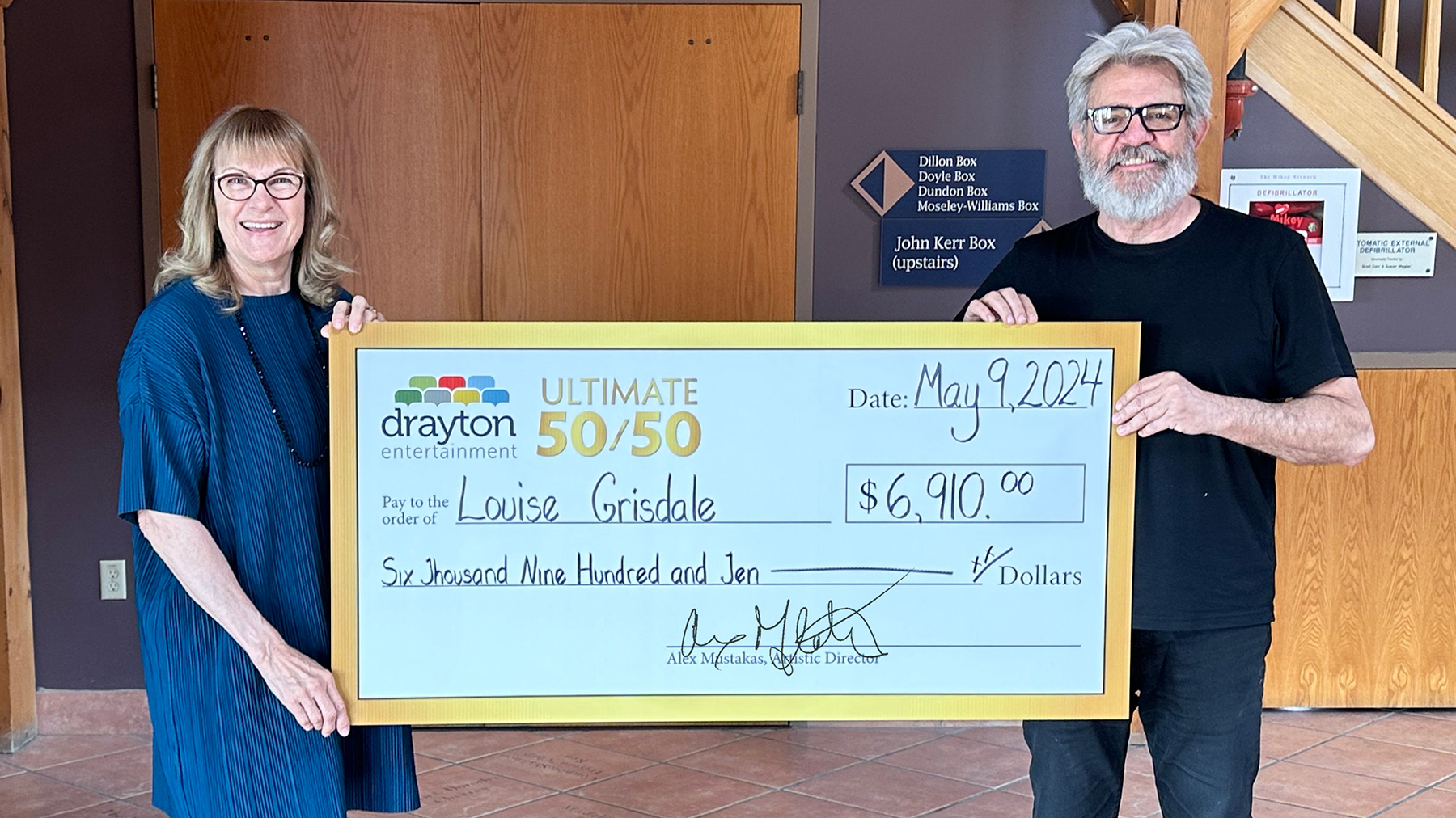 Louise Grisdale and Alex Mustakas with a big cheque at St. Jacobs Country Playhouse