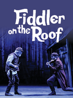 Production photo of Fiddler on the Roof showing the characters Tevye and The Fiddler dancing on stage.