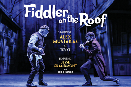 Production photo of Fiddler on the Roof showing the characters Tevye and The Fiddler dancing on stage.